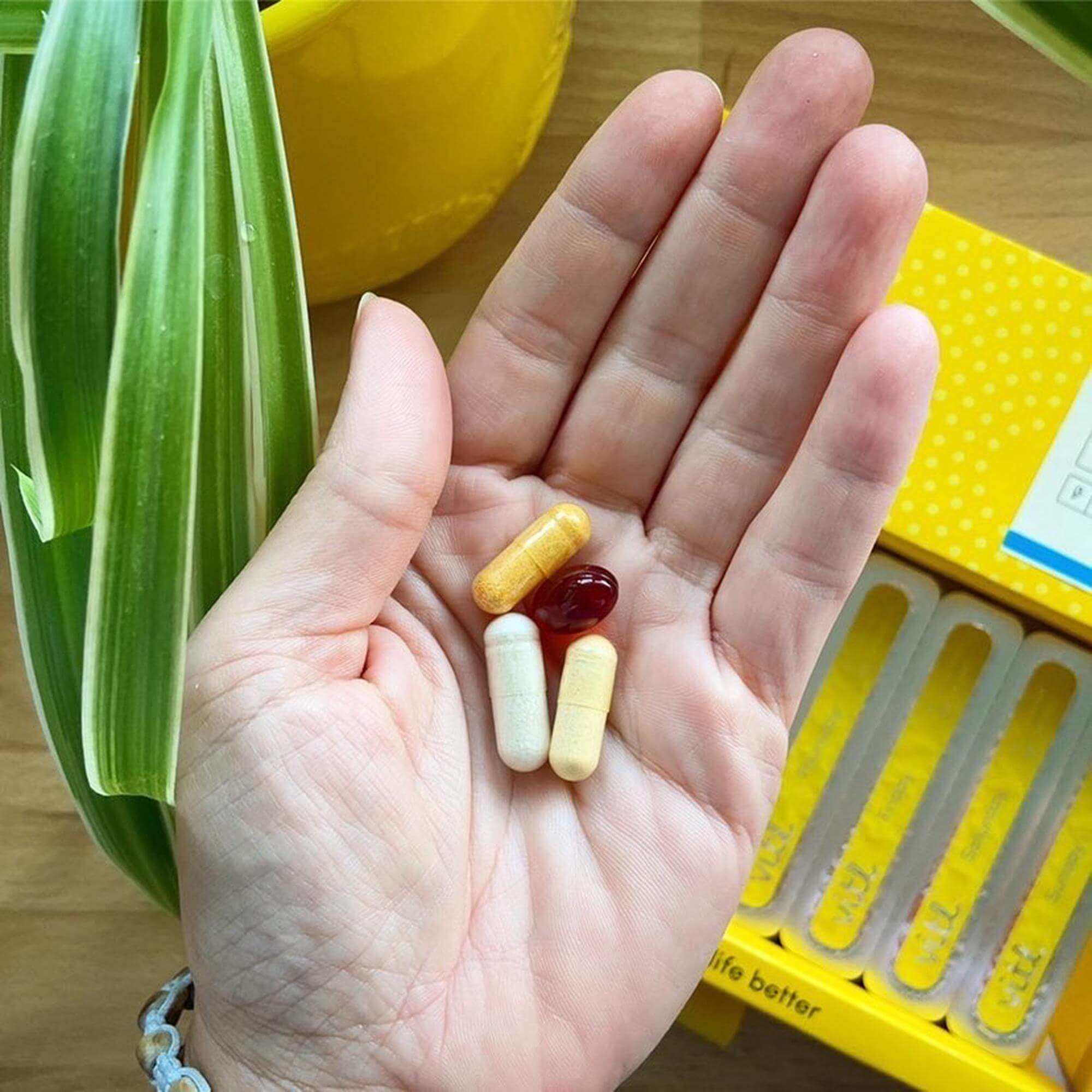 Person taking personalised vitamins
